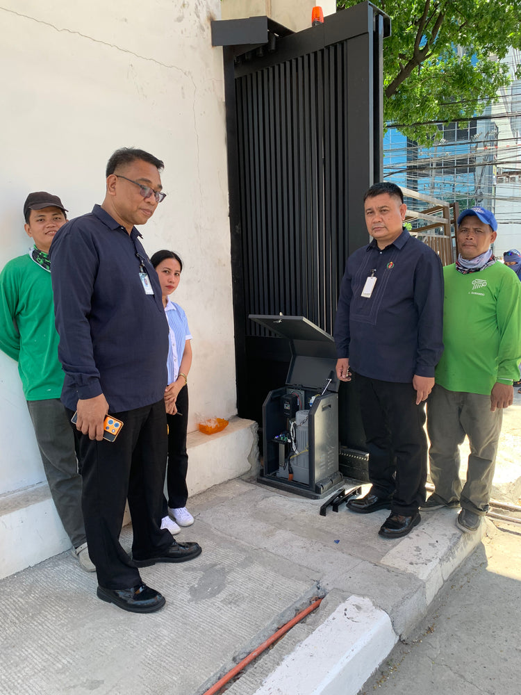 IRONGATE crew and client representatives beside the heavy-duty sliding gate motor at handover